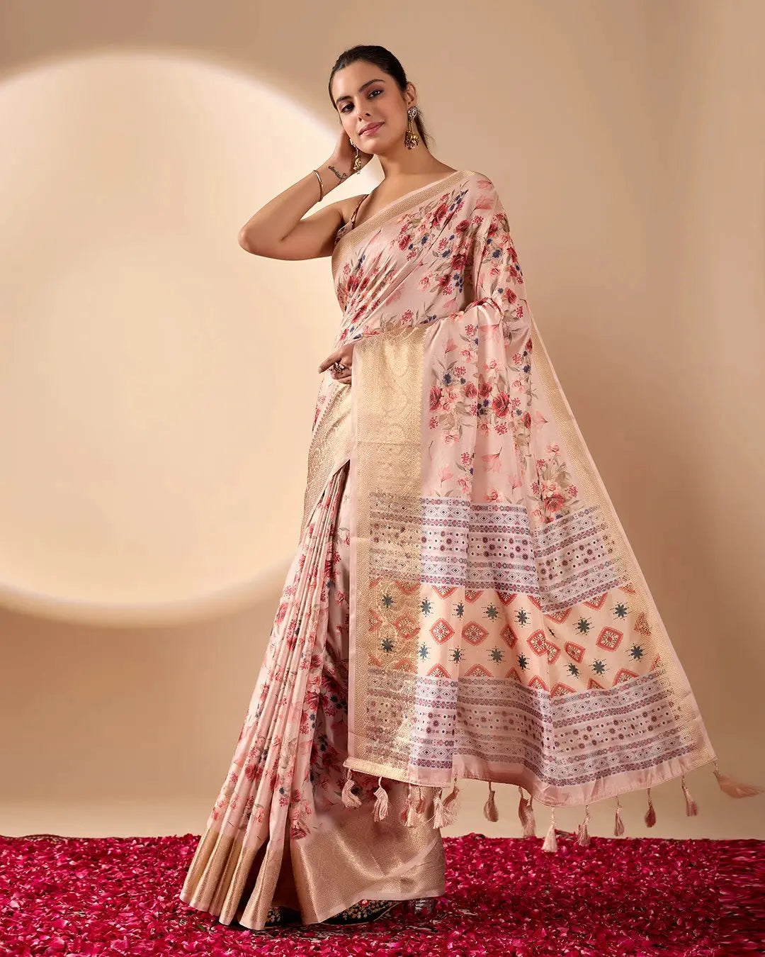 Woman wearing a floral saree with a plain background
